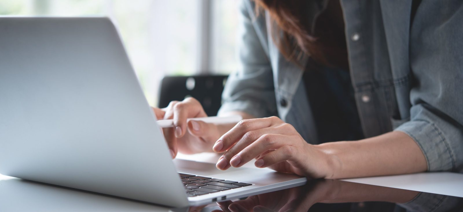 Woman typing in a laptop